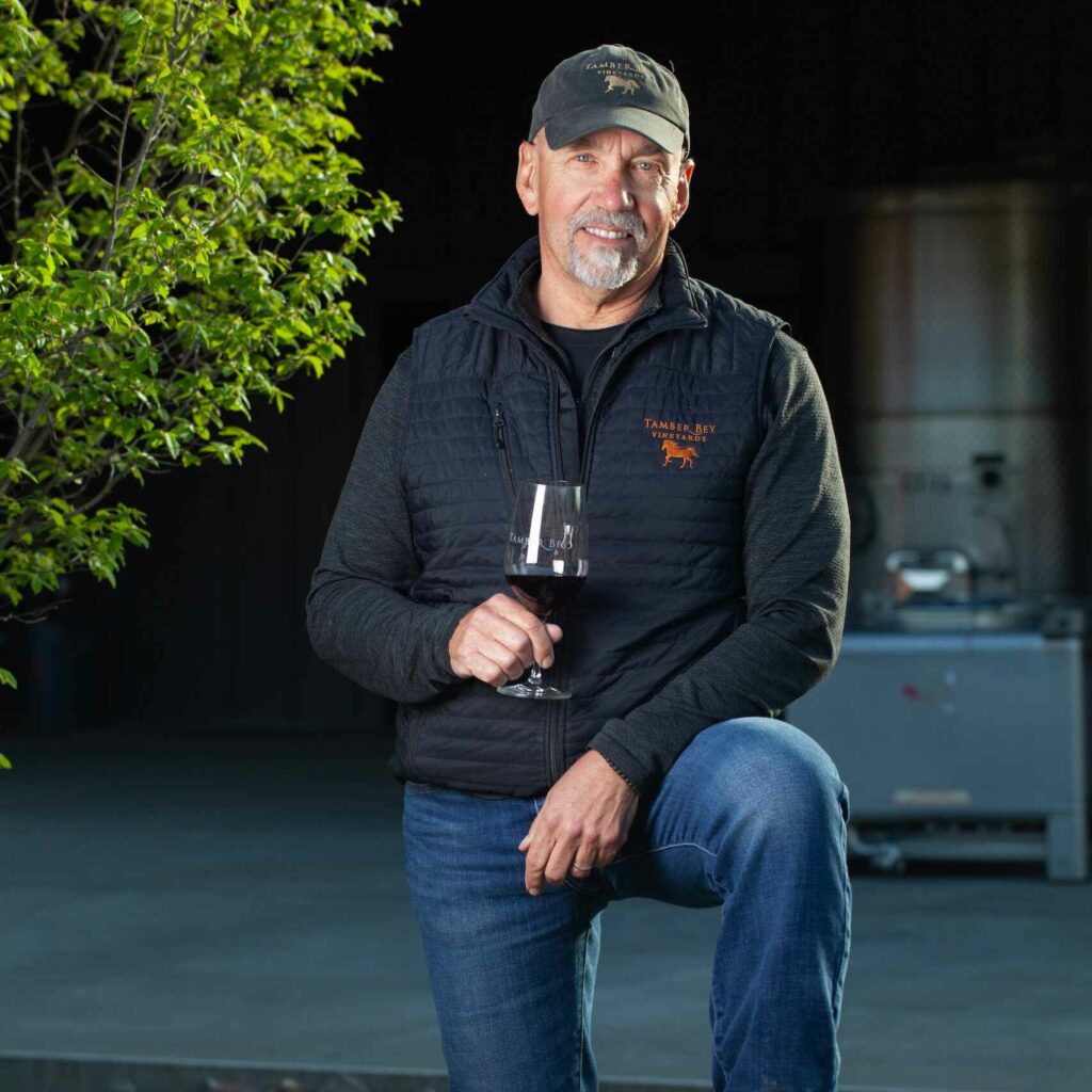 Barry with wine outside winery at night
