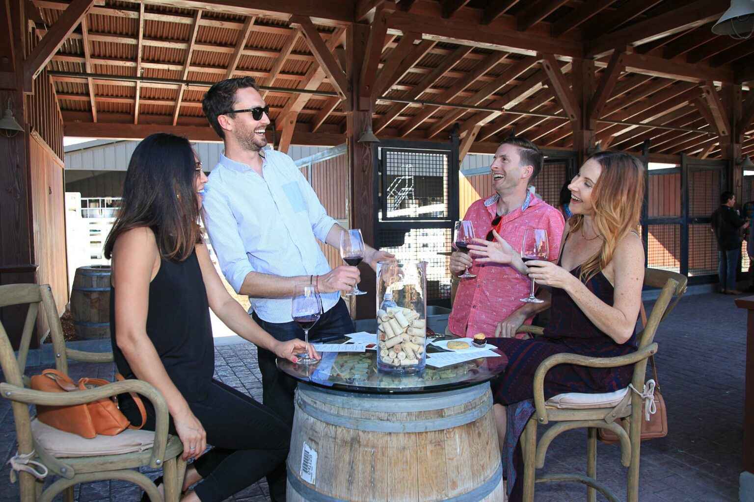 a group of people sitting around a table with a cake on it.