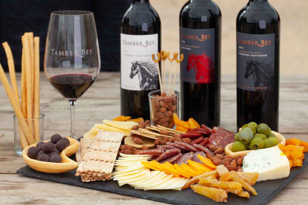 charcuterie board with three wines