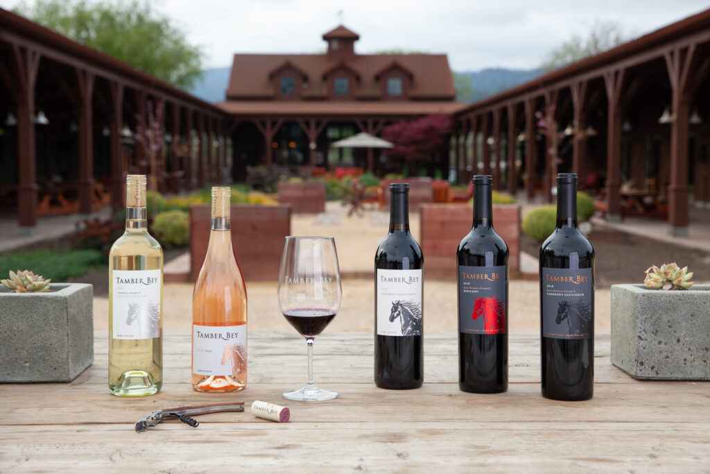Lineup of wines in front of horse stalls and courtyard